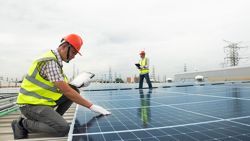 Persons working on a solar panel 