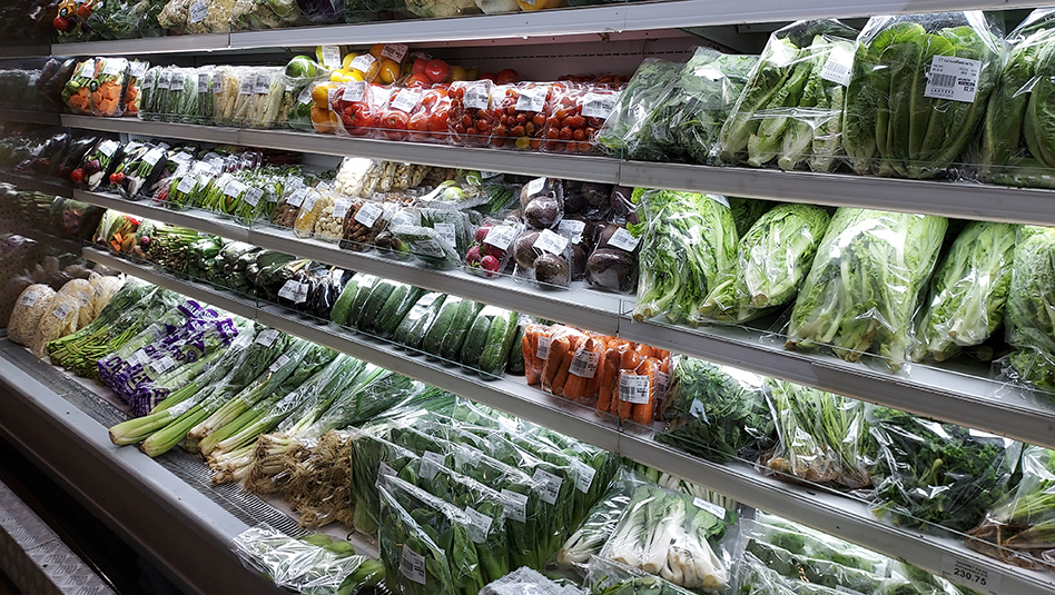 Colorful veggies at the refrigerated shelves of the grocery store