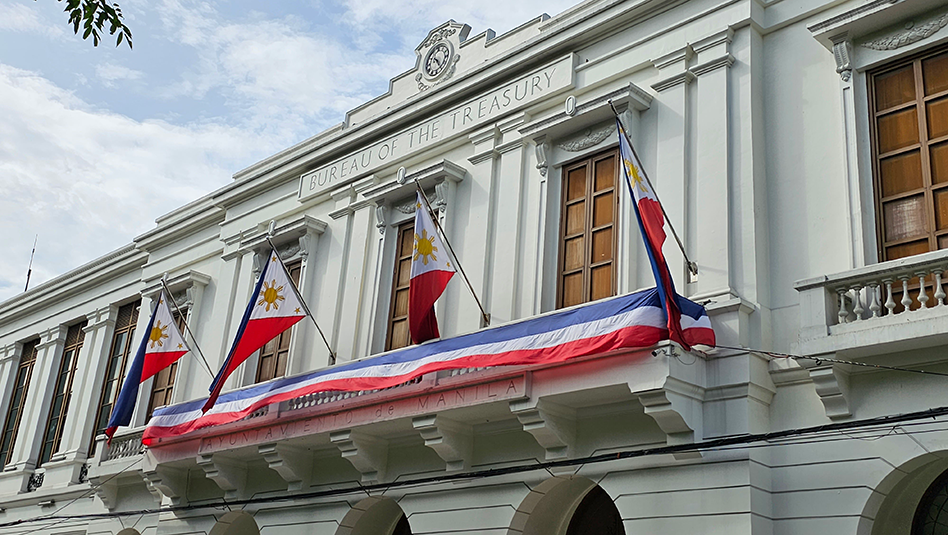 Façade of the Bureau of the Treasury with four Philippine flags.