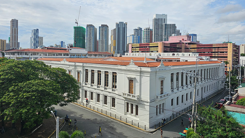 Top view of the Bureau of the Treasury building with other buildings in Manila at the background