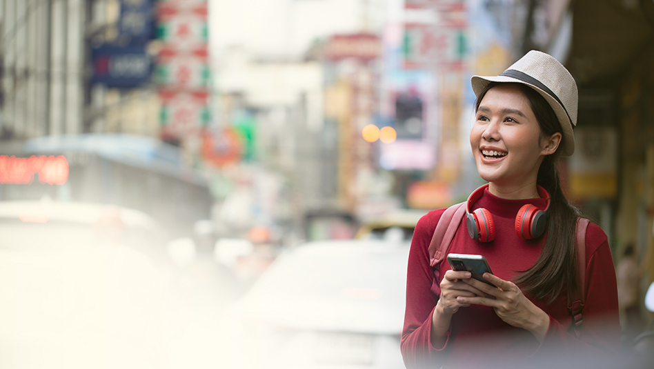 Girl wearing a red sweatshirt holding a mobile phone