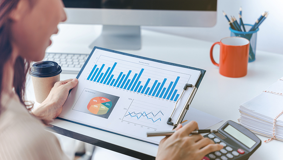 A person looking at a graph on paper